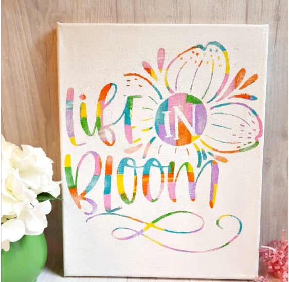 Beautiful canvas to decorate your home with flowers and rainbow colors saying Life in Bloom