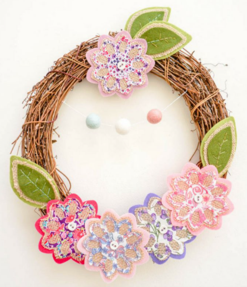 Grapevine wreath with spring flowers and leaves cut by die cutting machine added