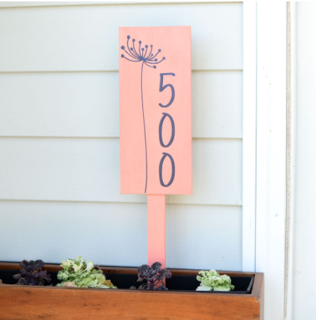 Address plaque on a stake to place in a planter box and display house numbers. Dandelion flower design on it. 