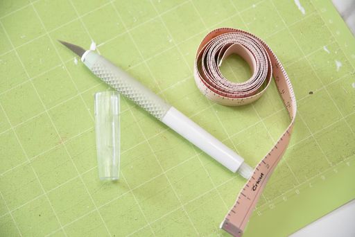 Cricut Trucontrol knife on a cutting mat with a measuring tape