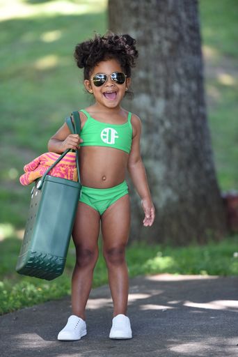 little girl wearing green bikini with monogram on bikini top applied with Cricut Sportflex Iron On Vinyl